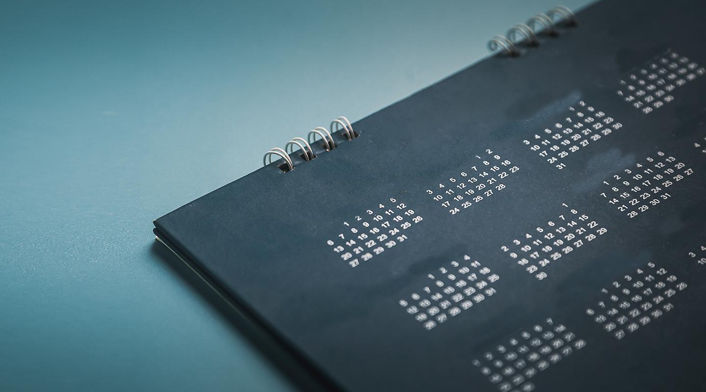 A black calendar on a blue background