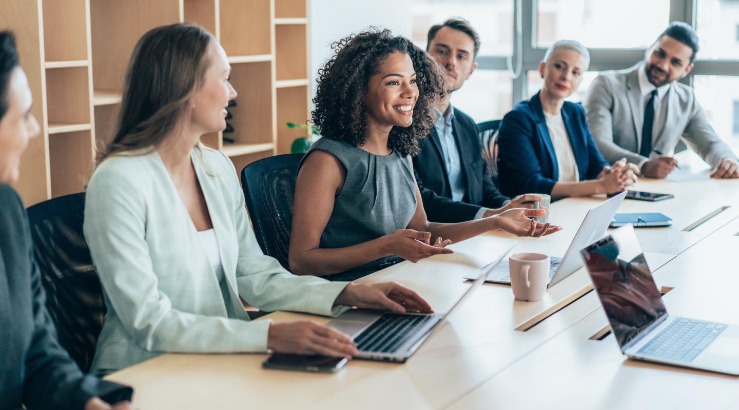 Smiling professionals sitting at an office conference room