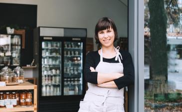 Retail-shop.jpeg Storeowner standing at the door of their small business storefront