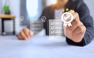 Male professional pointing at a checkmark and white graphic of documents with tasks checked off