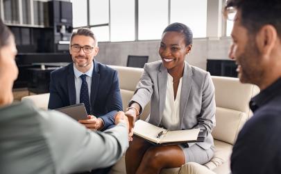 Business professionals smiling and shaking hands
