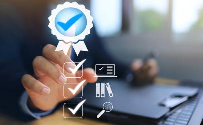 Male professional pointing to an image of a blue certification ribbon