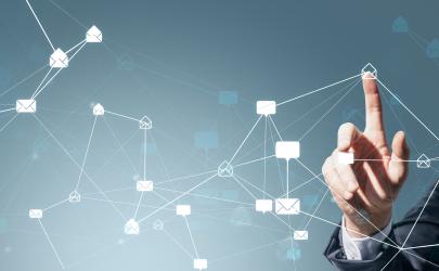 Male in suit pointing at white envelope icon, with web of other tech and envelope icons