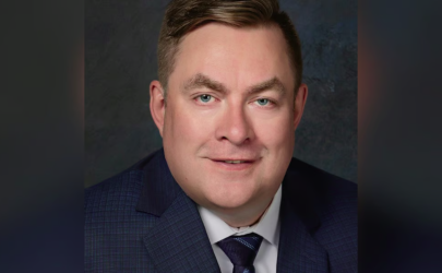 man with light hair and green eyes wearing a suit