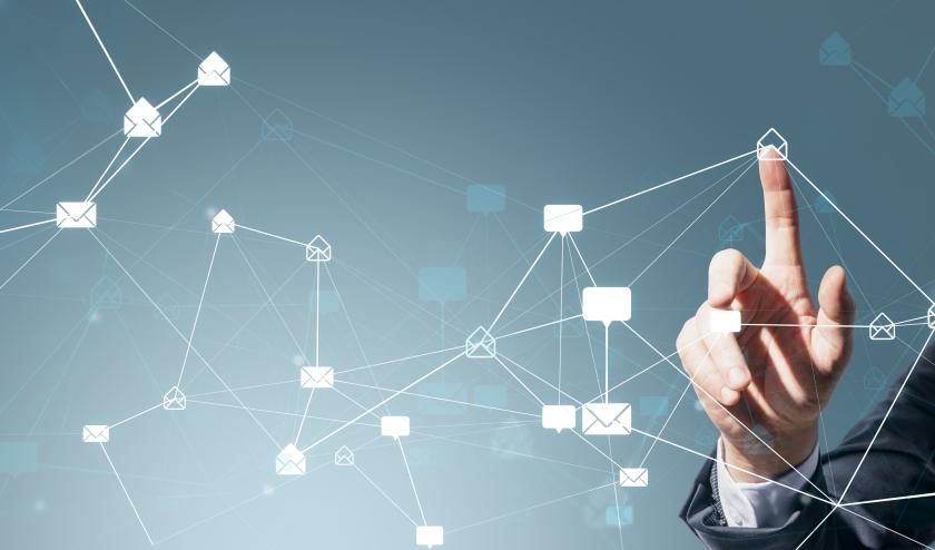 Male in suit pointing at white envelope icon, with web of other tech and envelope icons