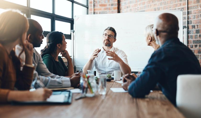 Employees holding a working group, talking in a boardroom