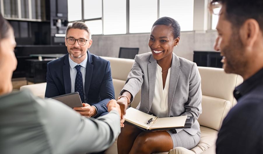 Business professionals smiling and shaking hands